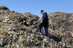 Mike Climbing Rocks at Ballintoy Harbor